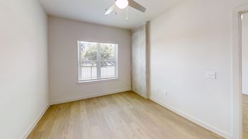 Empty bedroom with window and ceiling fan
